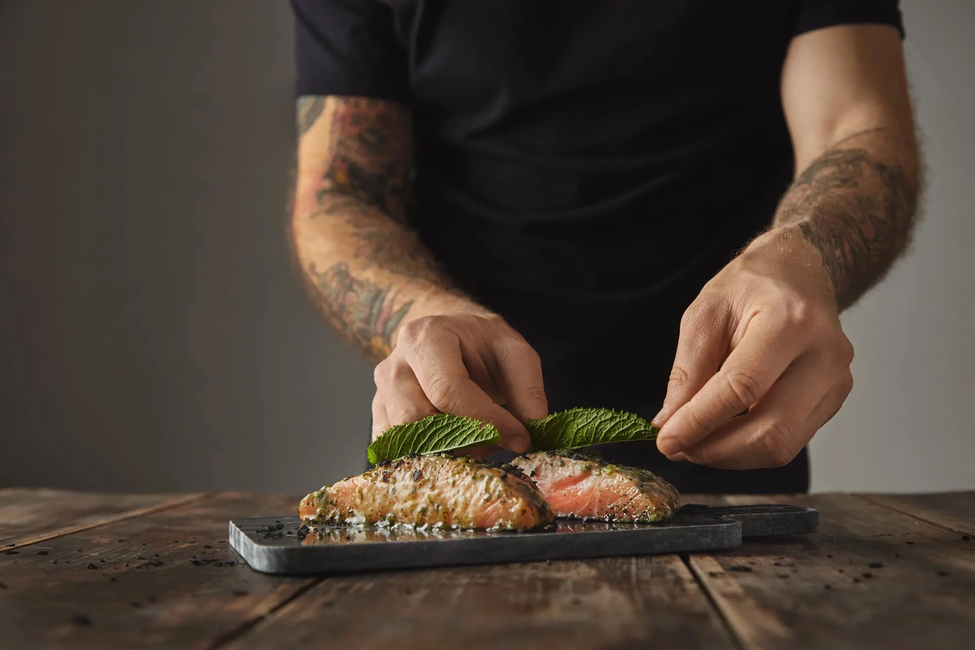 man cooking healthy salmon